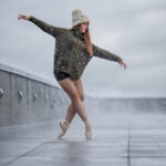ADT Principal Gillian-4038 girl in pointe shoes wearing a sweater and beanie while snow is falling