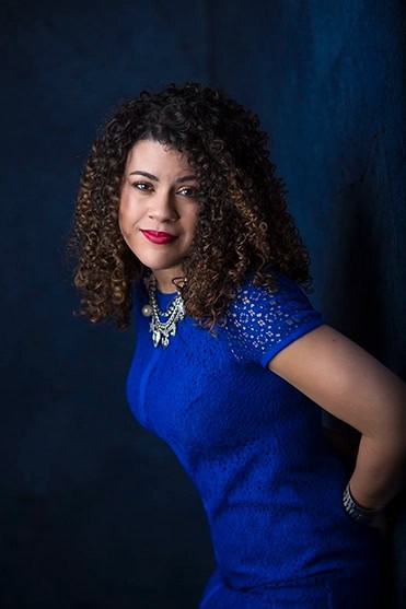 Studio portrait of a mature hispanic woman in a blue dress