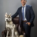 FRE-0128-copy-e1767147869878 man posing for a headshot with his dog