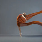 Falyn-Jones-4106-copy girl wrapped in an orange fabric while on pointe