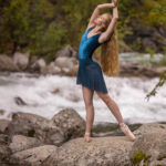 Falyn Jones-7372-2 girl posing on a rock in a short blue dress while by a rushing river