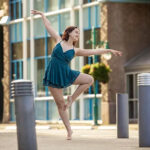 Hilary-Hanson-9058-copy girl in the city in a dance pose while wearing a green dress