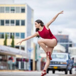 Juliet-6854-copy girl on point in a red leotard while in a city