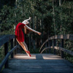Kali Dey-2503 girl in a red dress and pointe shoes leaning back and against a bridge railing