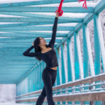 Layla Brent-1457 girl in a black outfit and bearfoot on a bridge and throwing up a red scarf