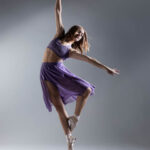 Makana & Nicolina-0338 girl doing a dance post in a purple dress inside of a studio