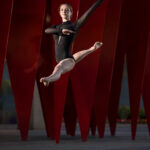 Siobhan-Witty-Daugherty-3258-copy girl in a black leotard leaping in front of a red sculpture
