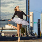 Skylar-2163 girl in the city on pointe and in a white tutu with her head back