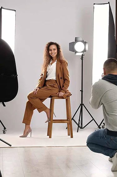 Woman in pants suit being professionally photographed