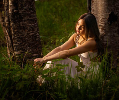 High school senior girls sitting in a golden hour light in a forest