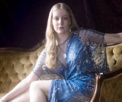 High school senior girl in blue dress photographed in a vintage glow