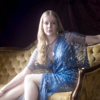 High school senior girl in blue dress photographed in a vintage glow